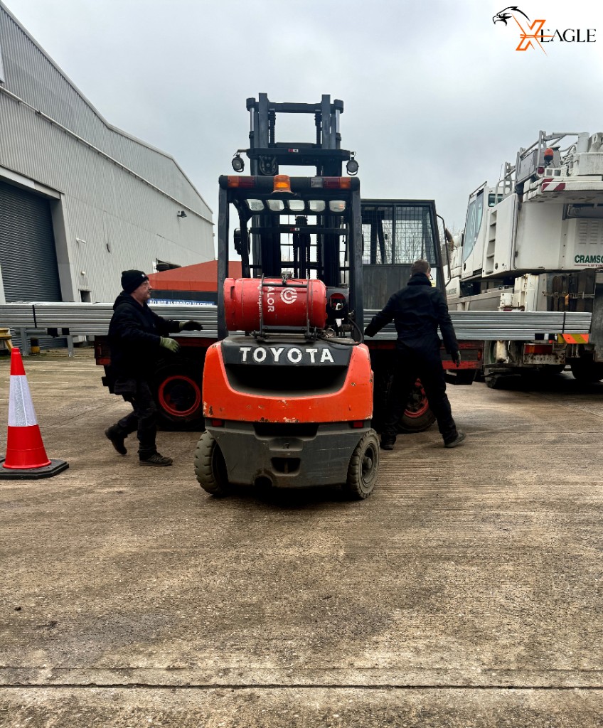 Two-man team operating forklift